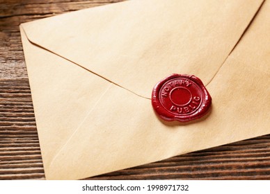 Envelope with notary public wax seal on table, closeup