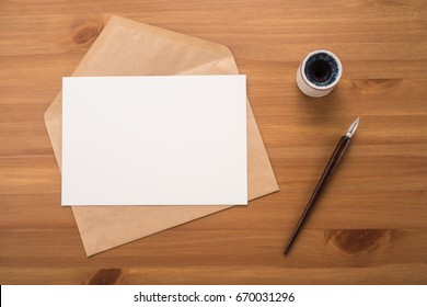 Envelope on a wood table - Shutterstock ID 670031296