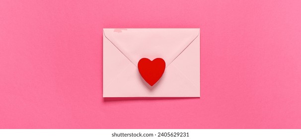 Envelope and red heart on pink background, top view. Valentine's Day celebration