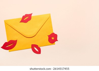 Envelope with red paper lips on beige background