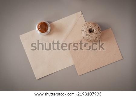 Envelopes, a rope and an ex-libris are fixed on a leather substrate. Flatlay.