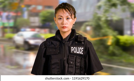 Enviromental Portrait Of Asian American Police Officer At Crime Scene