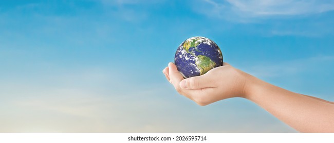 Environment day concept, Globe in hands over blue sky background. Save of earth. Elements of this image furnished by NASA