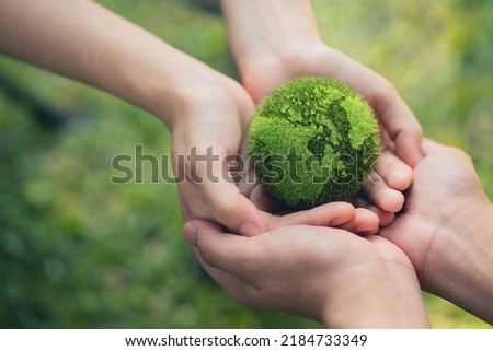Environment Earth Day In the hands holding green earth on Bokeh green Background, Saving environment, and environmentally sustainable. Save Earth. Concept of the Environment World Earth Day