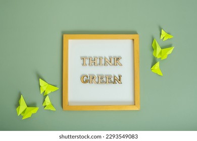 Environment for the future, concept of saving the planet. Think green text with paper butterflies.