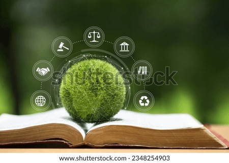 Environment Law. Green globe placed on a law book with icons. law for principles of sustainable environmental conservation.environmental protection and eco-friendly legislation law. Save earth.