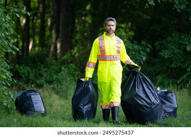 Environment plastic pollution. Volunteer collecting trash in the forest and holding a garbage bag. Environmental protection. Environmental Activist. Environmental conservation and waste pollution. - Powered by Shutterstock