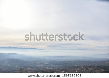 Environment pollution, foggy landscape of valley. Fog and pollution above the city of Nis, You can't see the city from smog Foto stock © 
