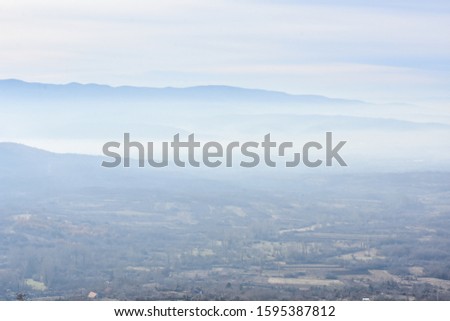 Environment pollution, foggy landscape of valley. Fog and pollution above the city of Nis, You can't see the city from smog Foto stock © 