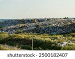 Environment pollution. Garbage pile in trash dump or landfill. Two bulldozers are working at a landfill.