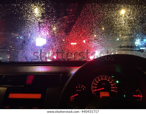 Environment of\
rainy night jam from inside the\
car