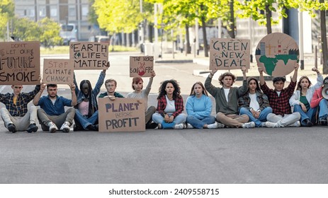 Environmental activists protesting for change - A group of activists gather in an urban setting, holding signs that call for action against climate change. Their placards bear powerful messages.