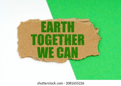 Environmental concept. On a white-green background lies a piece of cardboard with the inscription - Earth Together We Can