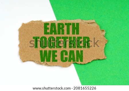 Environmental concept. On a white-green background lies a piece of cardboard with the inscription - Earth Together We Can