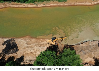 Environmental Conservation Issue. Machinery Mining River, Causing Siltation And Pollution 