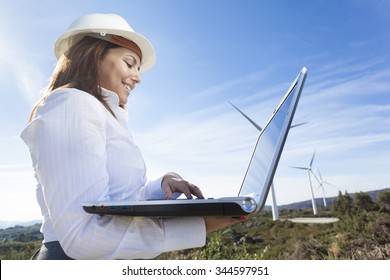 Environmental Engineer With A Laptop At Wind Farm