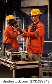 Environmental engineer uses tablet on offshore rig under the northern lights, ensuring petroleum and fuel extraction on the platform. Compliance with oil and gas production industry.