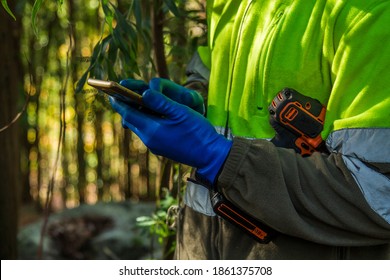 Environmental Or Forestry Worker Checking His Mobile Phone