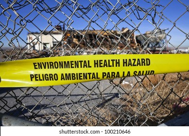 Environmental Health Hazard Warning Tape On A Chain Link Fence.