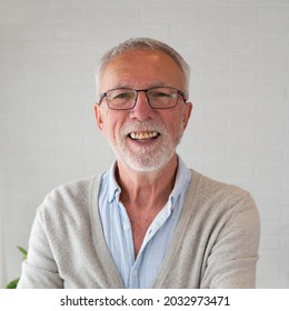 Environmental Indoors High Key Portrait Of An Elderly Bearded Man With Eyeglasses