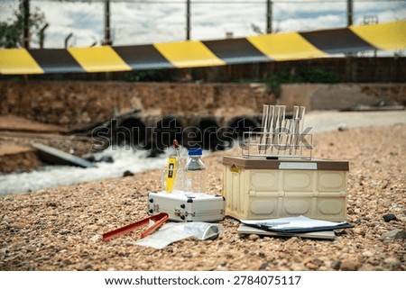 Environmental Inspector preparing testing kit during industrial wastewater pollution investigation and hazardous river contamination monitoring.