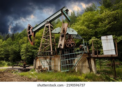 Environmental Pollution, Old Oil Well And Oil Pump Derrick.