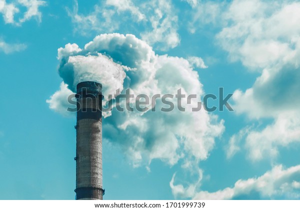 Environmental pollution, environmental problem, smoke\
from the chimney of an industrial plant or thermal power plant\
against a cloudy\
sky