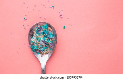 Environmental pollution and water microplastic. Micro plastic with spoon