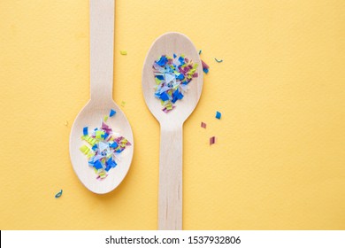 Environmental Pollution And Water Microplastic. Micro Plastic With Spoon