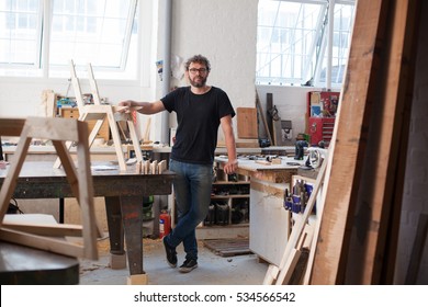 Environmental portrait of a furniture designer maker in his workshop