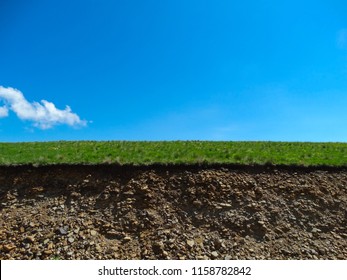 Environmental Protection. The Land Of The Caucasus Is Fertile And Rich In Minerals In The Context. Rockfall, Collapse, Ravine. Sky, Grass, Earth-colored Stripes In Nature.