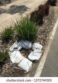 Environmental Sandbags Around A Drain Plate By The Bike Path Near Tustin Ranch.