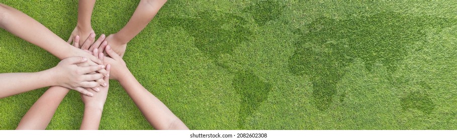 Environmental, social and corporate governance ESG, CSR and SDG Sustainable Development Goal on energy saving collaboration of children teamwork hands on green background for World environment day - Shutterstock ID 2082602308