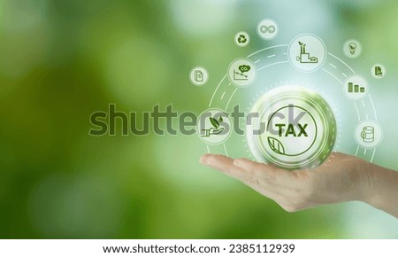 Environmental tax breaks concept. Holding glass ball with green tax icons. Using environmental  taxes, carbon tax, environmentally beneficial tax incentives in order to achieve environmental targets. 