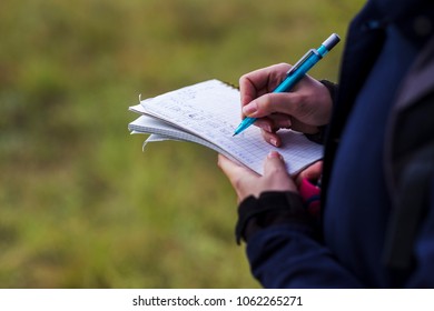 Environmentalist taking notes on field