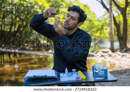 The environmentalist is testing a water Stream in the forest. Environment, science.