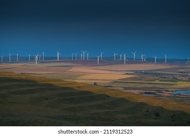 Eolian wind turbines farm in Dobrogea, Romania, during a cloudy morning. Alternative ways for green energy.