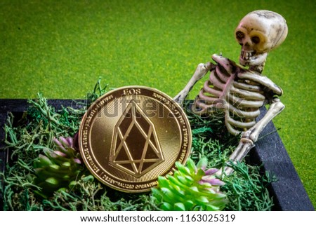 EOS coin in a graveyard and a skeleton.