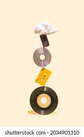 EP Vinyl Records, Cd, Cassette Tape, CD, MP3 Player And Cotton Cloud Shaped Prop On The Top Of Each Other. History Of Music Mediums Concept Made On Beige Background.