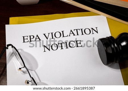 EPA Violation Notice Document Set on Wooden Desk – Environmental Protection Infraction Report

