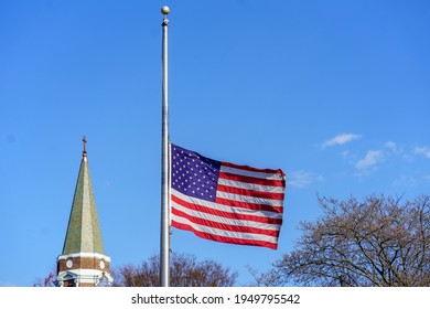 Ephrata, PA, USA - April 4, 2021: The USA American Flag Flies At Half-mast In Tribute To Mourn A Fallen Police Officer.