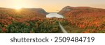 Epic Aerial Panorama New England Autumn Lake Willoughby at Sunrise. Colorful Fall Foliage Sun Rising Over Trees Road Leads to Lake Vermont October