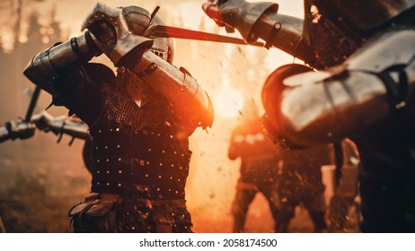 Epic Battlefield: Two Armored Medieval Knights Fighting with Swords. Dark Ages Army Warfare, Bloody Conflict. Action Battle of Warrior Soldiers. Cinematic Sun Light, Historic Reenactment.