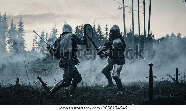 Epic\
Battlefield: Two Armored Medieval Knights Fighting with Swords.\
Dark Ages Army Warfare. Action Battle of Armed Warrior Soldiers,\
Killing Enemy. Cinematic Historical\
Reenactment.