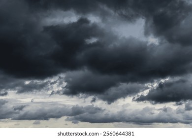 Epic Dramatic storm dark gray black cumulus rain clouds sky background texture, thunderstorm
