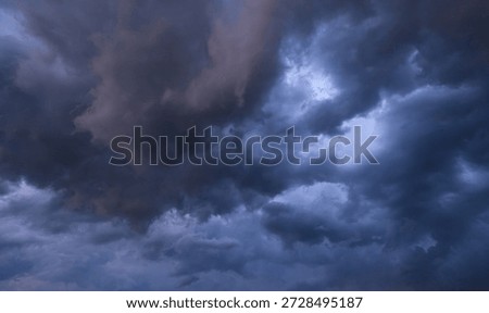 Epic Dramatic Storm sky, dark grey clouds against blue sky background texture, thunderstorm