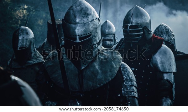 Epic Invading Army of Medieval Soldiers\
Marching on Battlefield, Armored Warriors with Swords. War, Battle,\
Conquest. Dramatic Historical\
Reenactment.