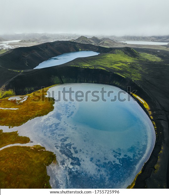 Epic
landscape in Iceland. Blue crater lake on a background of black
volcanic desert. Top view by drone. Vertical
photo.