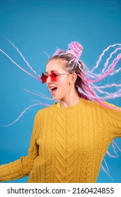Epic portrait of happy woman dancing, excited and emotional person. Young student, creative freelancer with colorful hair and afro braids dreadlocks moving, positive emotion, ecstatic feeling, shout