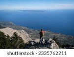 Epic scenery with hiker on top of Mount Ainos, the tallest mountain on the Ionian island of Cephalonia